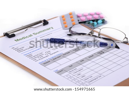 Blank medical record and some pill on white background.