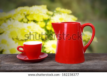 Hot drink served to someone in the flower garden in spring time.