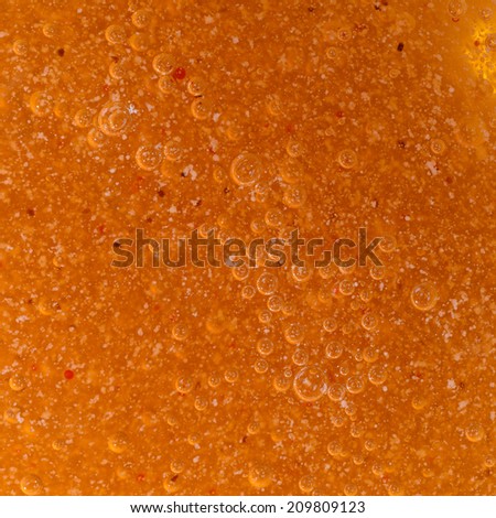 Close-up photo of air bubble of scrub oil for skin treatment.