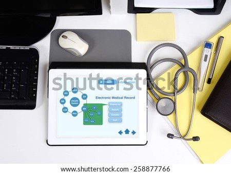 Top view of doctor working desk and tablet shown the electronic information.