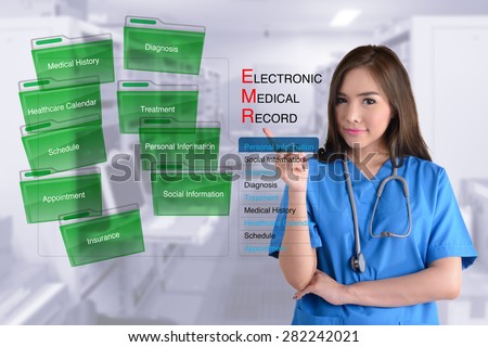 Female doctor in blue uniform show how electronic medical record work.