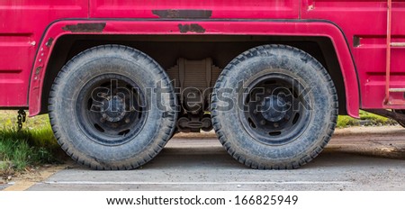 Wheels of red trucks.Wheels of truck parking at the park.