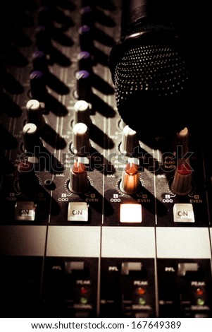 Still Life of microphone and audio mixers.