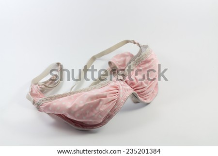 Old Pink Bra with white polka dots on a white background.