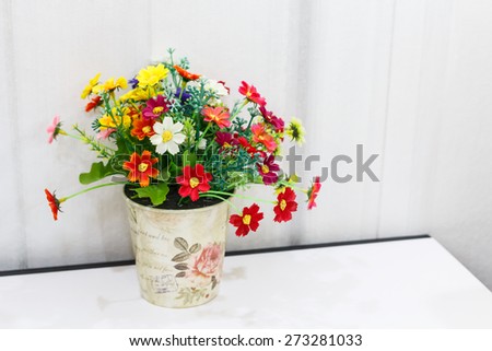 Decorative flower in ceramic planter.