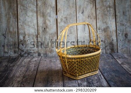 Wicker basket on the wooden floor.Wicker baskets, beautiful crafts of Thailand.