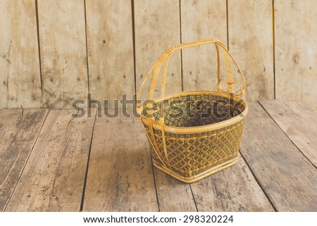 Wicker basket on the wooden floor.Wicker baskets, beautiful crafts of Thailand.