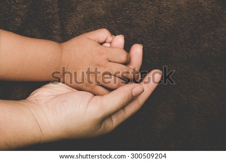 The hands of children and parents.