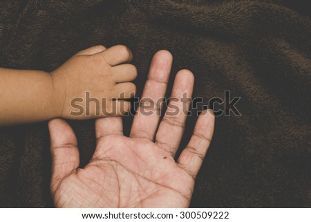 The hands of children and parents.