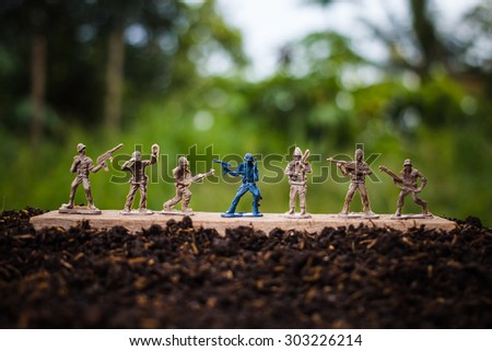 miniature toy soldiers are arrayed on the ground.