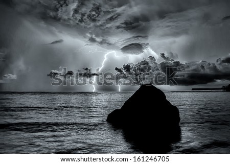 Lightning strike over the ocean in HDR and black & white