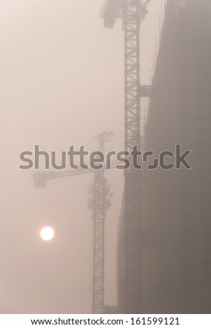 Construction site in heavy fog, located in Harbin City, Heilongjiang Province, China.