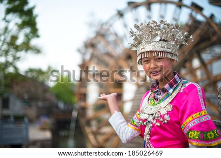 A girl dressed in ancient Chinese Miao nationality clothing. Located in Lijiang Ancient City, Yunnan Province, China.