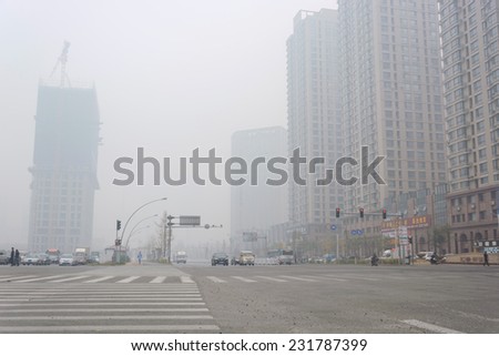 SHENYANG, CHINA - OCTOBER 31, 2014: City in a heavy hazy weather. The deterioration of air quality resulted in low horizontal visibility. Located in Shenyang City, Liaoning Province, China.