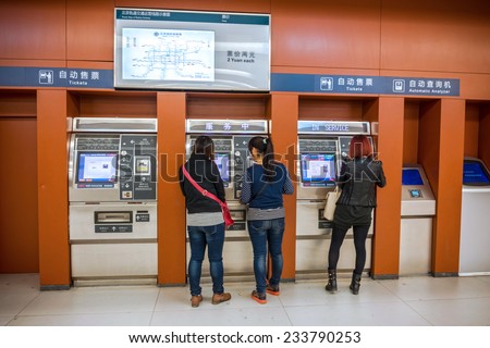 BEIJING, CHINA - OCTOBER 24, 2014: Automatic ticket of Beijing Subway. People are buying tickets. Located in Beijing Subway, Beijing, China.