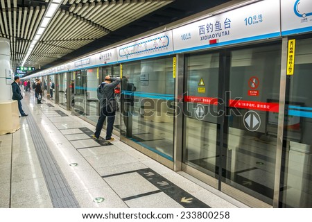BEIJING, CHINA - OCTOBER 24, 2014: Beijing Subway. People are waiting. Located in Beijing Subway, Beijing, China.