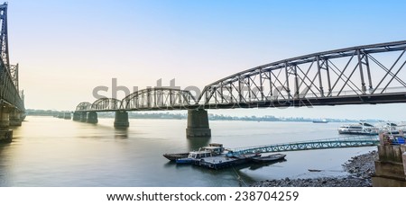 Yalu River Broken Bridge and Yalu River at morning. In the distance is North Korea. Located in Dandong City, Liaoning province, China.