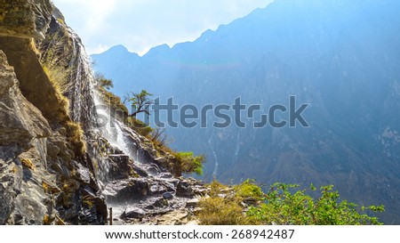 Cascade in the hiking path (the high road) of Tiger Leaping Gorge. Located 60 kilometres north of Lijiang City, Yunnan Province, China.