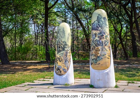 Shenyang, China - April  28, 2014: Decorative stone pillars. The painting is traditional Chinese landscape painting. Located in Shenyang City, Liaoning Province, China.