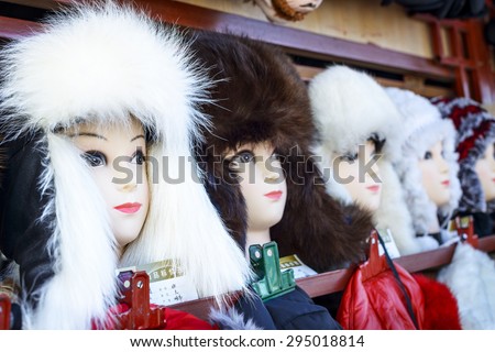 Harbin, China - January 11, 2015: Fur hats in a roadside kiosk. 27th China Harbin Sun Island International Snow Sculpture Art Expo. Located in Sun Island of Harbin City, Heilongjiang, China.