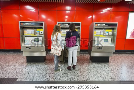 Hong Kong - February 10, 2015: Single Journey Ticket Issuing Machine. People are buying tickets. Located in Hong Kong Metro (Mass Transit Railway, MTR), Hong Kong.