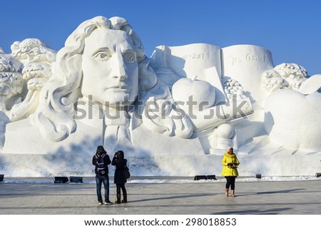 Harbin, China - January 11, 2015: Newton snow sculpture. People are walking. 27th China Harbin Sun Island International Snow Sculpture Art Expo. Located in Harbin City, Heilongjiang Province, China.