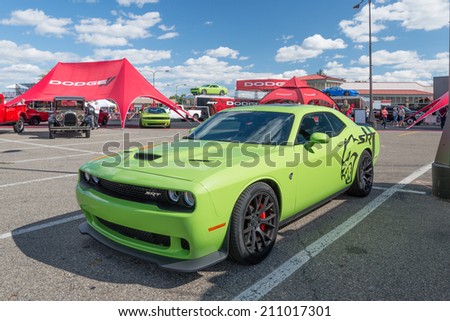 ROYAL OAK, MI/USA - AUGUST 14, 2014: A 2015 Dodge Challenger SRT Hemi Hellcat car, two Dodge Challengers, and a Viper at the Woodward Dream Cruise, the world's largest one-day automotive event.