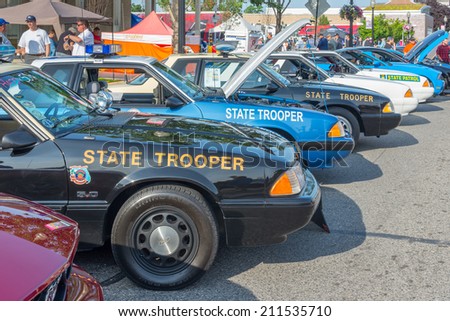 FERNDALE, MI/USA - AUGUST 16, 2014: Five police cars at the Emergency Vehicle Show, at the Woodward Dream Cruise, the world\'s largest one-day automotive event. Woodward is a National Scenic Byway.