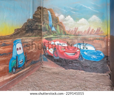 TUCUMCARI, NM/USA - MAY 9, 2013: Route 66 mural depicts cartoon characters Lightning McQueen (a NASCAR vehicle) and Sally Carrera (a Porsche 996) from the Pixar movie Cars at the Blue Swallow Motel.
