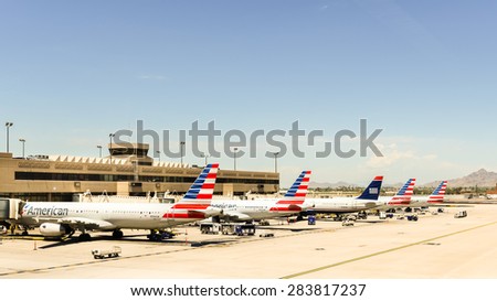 PHOENIX, AZ/USA - May 2, 2015: Five American Airlines airplanes parked at a Phoenix Sky Harbor International Airport (PHX) terminal.
