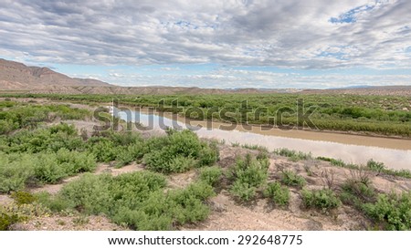 The Rio Grande River flows against a backdrop of Sierra Del Carmen Mountains at the Boquillas Canyon Overlook, in Big Bend National Park, Texas. The river is the border between the USA and Mexico.