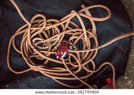A rope with a safety device on a dark background.
