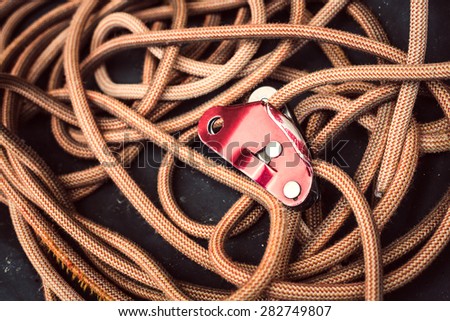 A rope with a safety device on a dark background.