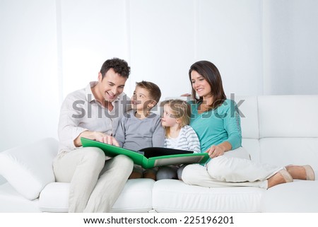 father reads a story to his children