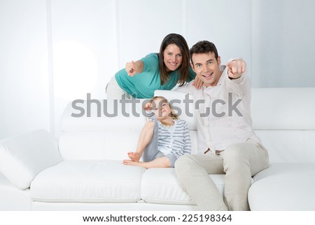 happy family pointing to the camera