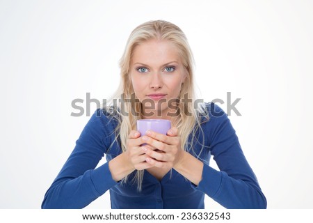 blonde woman makes tea in the morning - serious girl with infusion on white background