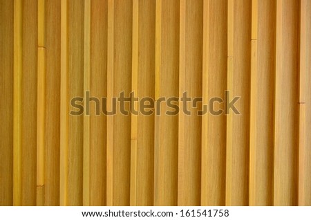 Indoor polished wooden wall in light brown or birch color with vertical lines