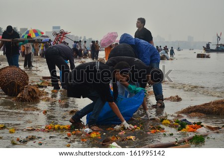 Mumbai, India - Circa September 2013 - Volunteers Helping To Clean Up The Beach During The Rain After The Immersion Of Hindu God Ganesha