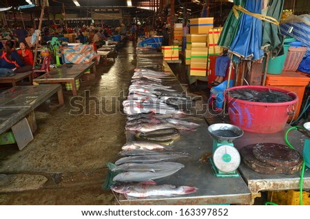 Pakxe, Laos - circa October 2013 - Vendors selling fresh water fishes lying on a platform  in local market