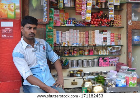 Mumbai,India - Circa January 2014 - male vendor selling snacks and goods at his small kiosk