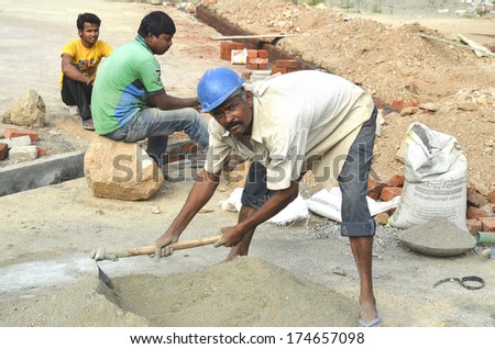 Mumbai, India - January 16, 2014 - Worker Mixing Cement At Construction Site In Mumbai