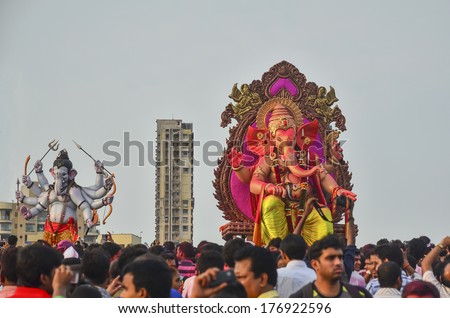 Mumbai, India - September 17, 2013 - Devotees bringing Hindu God Ganesha into the ocean during Ganesha Festival
