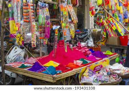 Mumbai, India -  March 15 - Stall selling colorful powder and toys during Holi Festival at local market