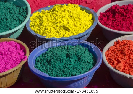 Trays of color powder in various vibrant hues for sale during India\'s Holi Festival