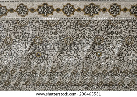 Jaipur, India - March 28, 2014 - Colorful ceiling decorated with pieces of glass in floral patterns at Amber Fort Jaipur India opened for public