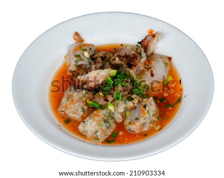 Vietnamese steamed rice cake stuff with minced pork and chive with grilled pork and spicy sauce in a white plate isolated on white