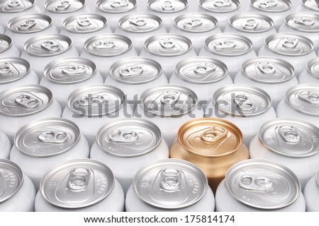 One Gold Can Among a Group of Aluminum Beverage Cans