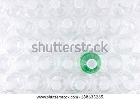 Overhead View of Plastic Water Bottles with One that has Green Colored Contents