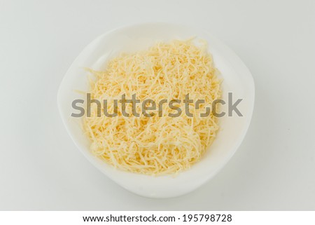 small grated cheese lies in a plate and is ready to use