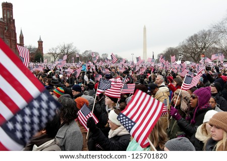 WASHINGTON, D.C. - JANUARY 21: Crowd waving flags at 2013 Inauguration of Barack Obama on January 21, 2013 in Washington, D.C.